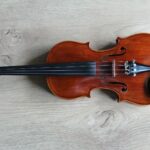brown violin on white textile